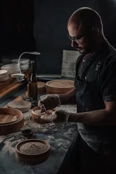 executive chef preparing wood fired pizza
